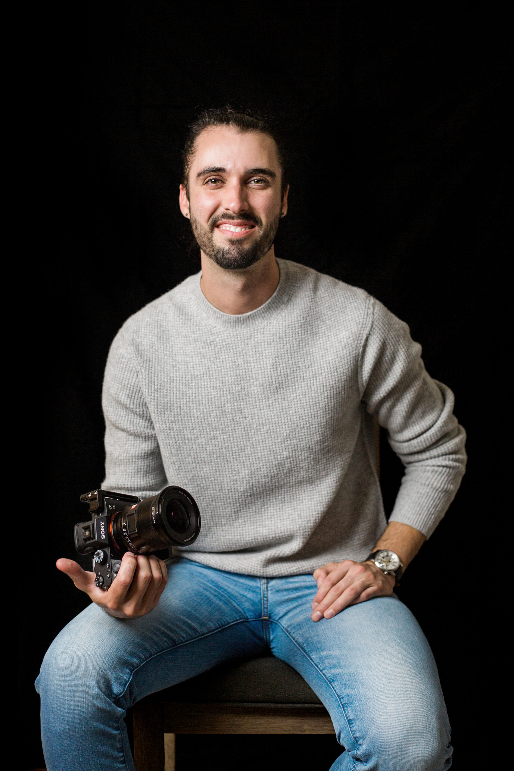 Cody Smith, founder of REVAMP Visuals, holding a Sony cinema camera